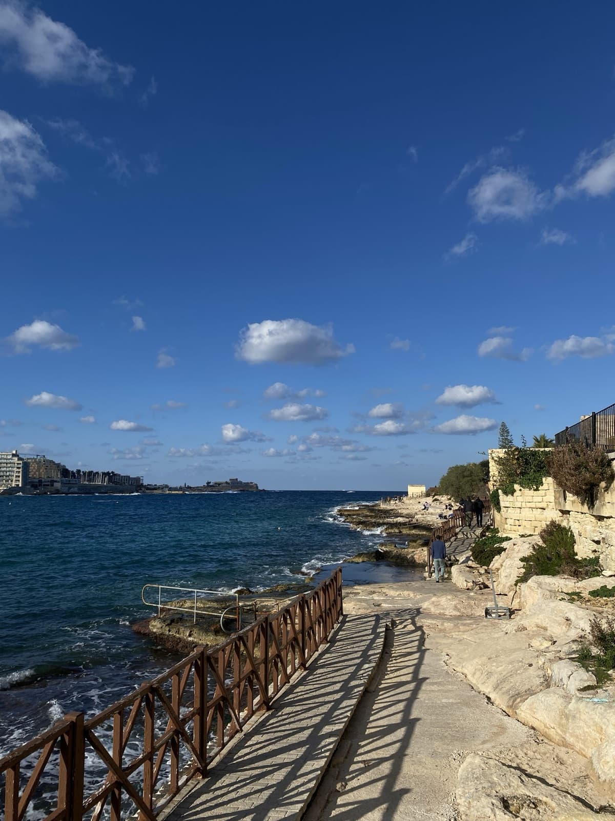 A sunny coastal walkway along the sea in Sliema
