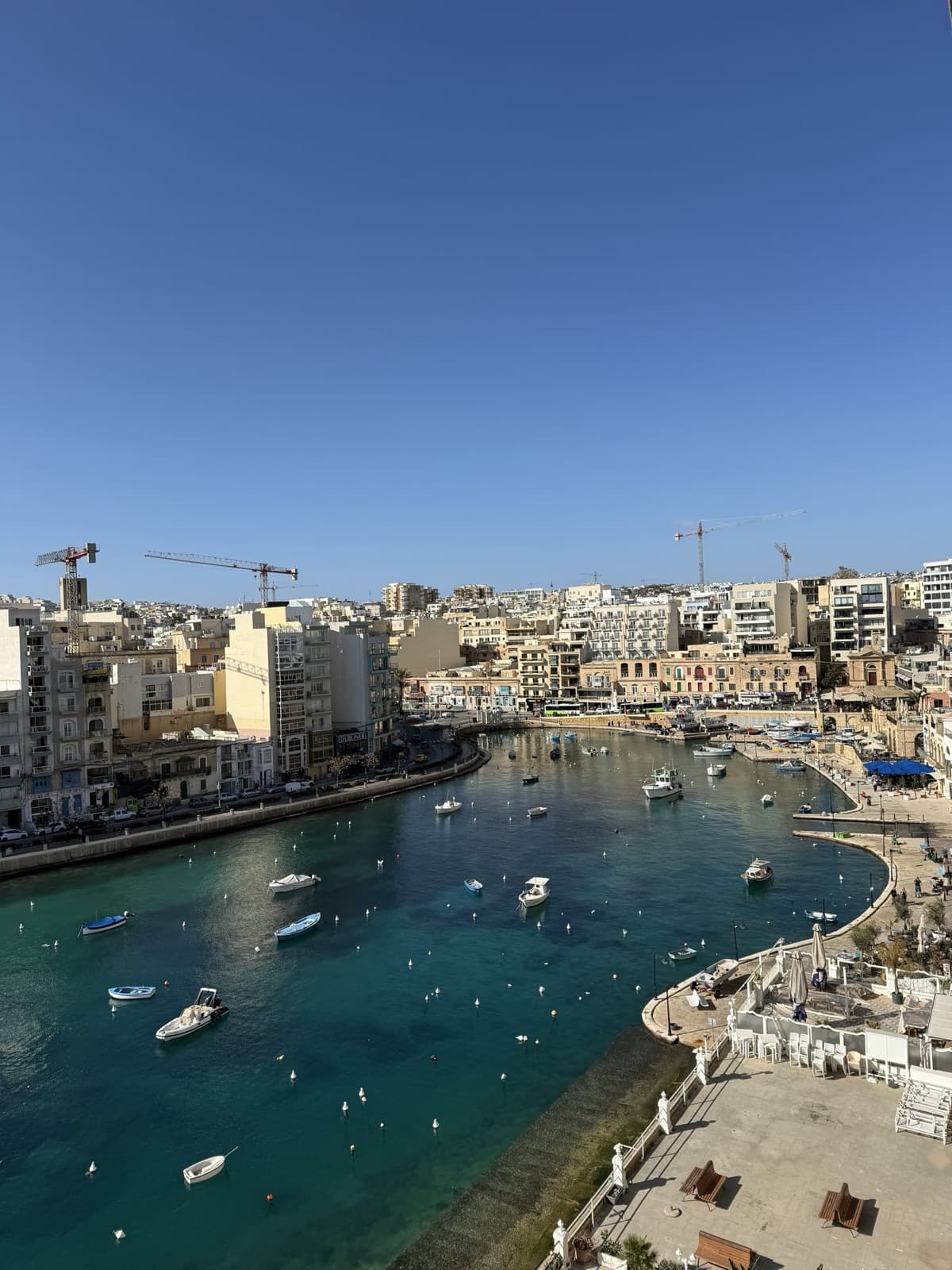 Spinola Bay in St Julian's with its town and moored boats seen from above